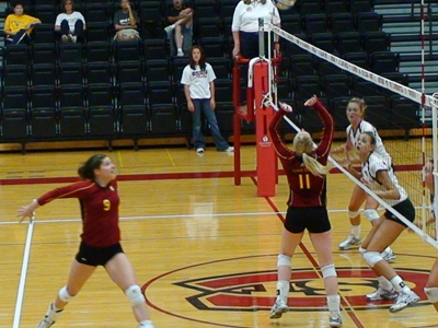 Samantha Fordyce (#11) sets the ball up for an attack by Sarah Lark (#9) in action versus Wayne State (Neb.).