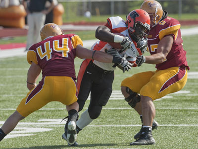 Ferris State's Matt Ryan (#44) and Muneer Bawayeh (#97) combine for a stop in Saturday's game versus Findlay (Photo by Ed Hyde)