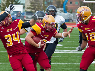 FSU quarterback Tom Schneider runs with the ball versus Michigan Tech (Photo by Scott Whitney)