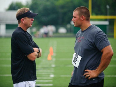 Former Bulldog Jake Visser (right) talks with sports coordinator Mark Ellis (left) at tryouts for the movie "Touchback" (Photo courtesy of Joel Hawksley - MLive.com)