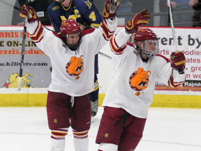 Casey Haines (left) and Blair Riley (right) celebrate the Bulldogs' dramatic 3-2 victory over Michigan.  (Photo courtesy of The Pioneer)