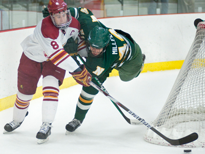 Cody Chupp fends off Northern Michigan's TJ Miller for the puck during Friday's overtime tie. (Photo by Ed Hyde)