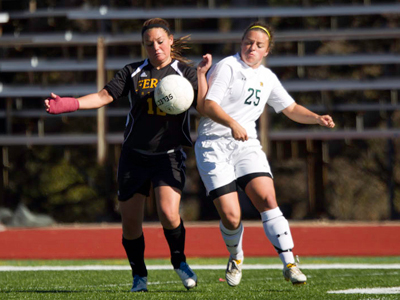 Kelsey Aubil's battles Northern Michigan's Caitlin Glendenning for the ball during Sunday's regular-season home finale.  (Photo by Ben Amato)